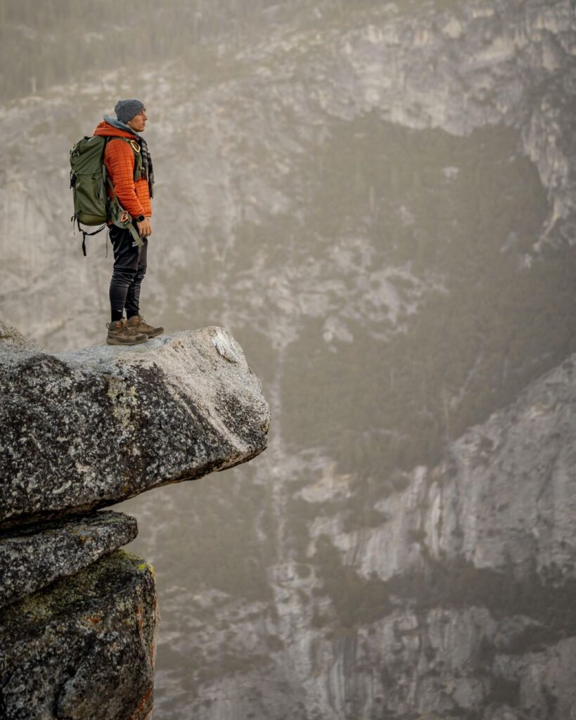 A man standing on the edge of a cliff, showing that EMDR can help with anxiety.