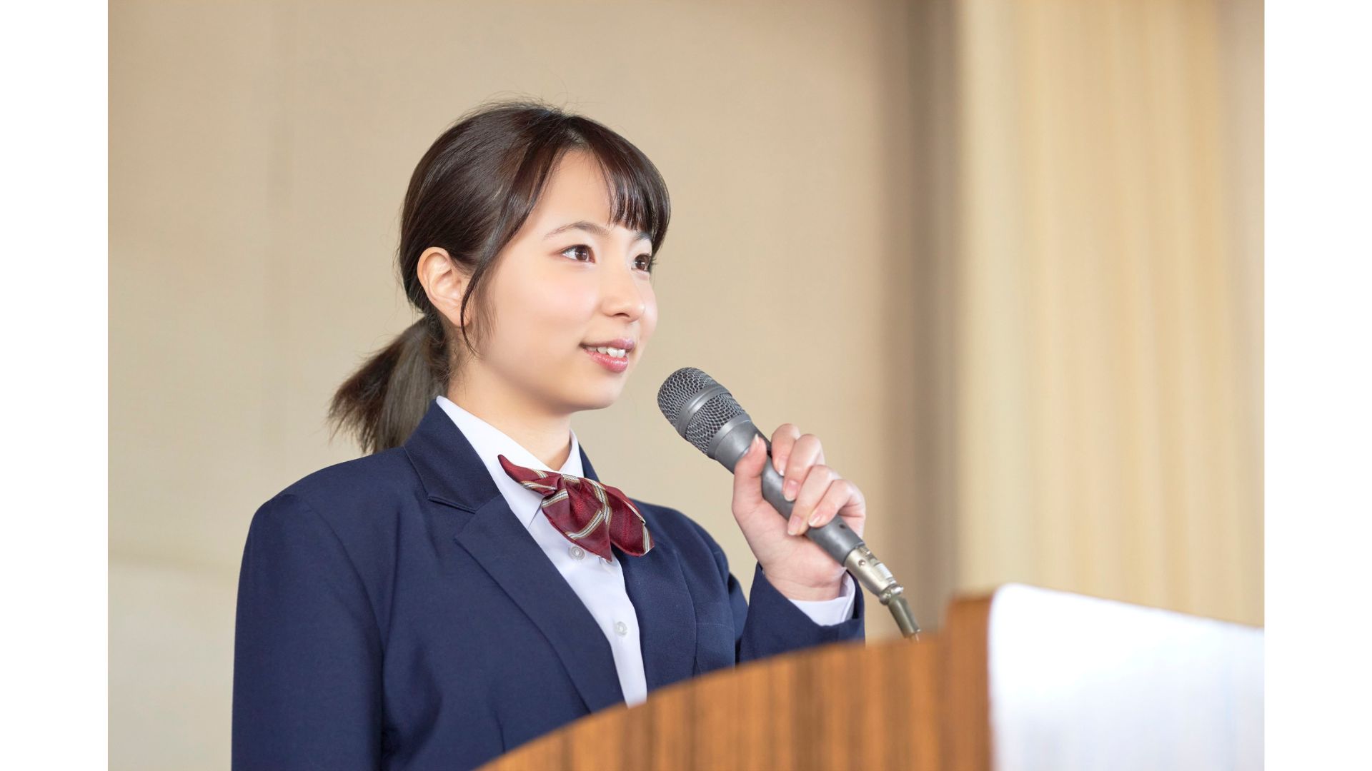 Female Speaking A picture of a female making a speech, showing that hypnotherapy can help with public speaking.