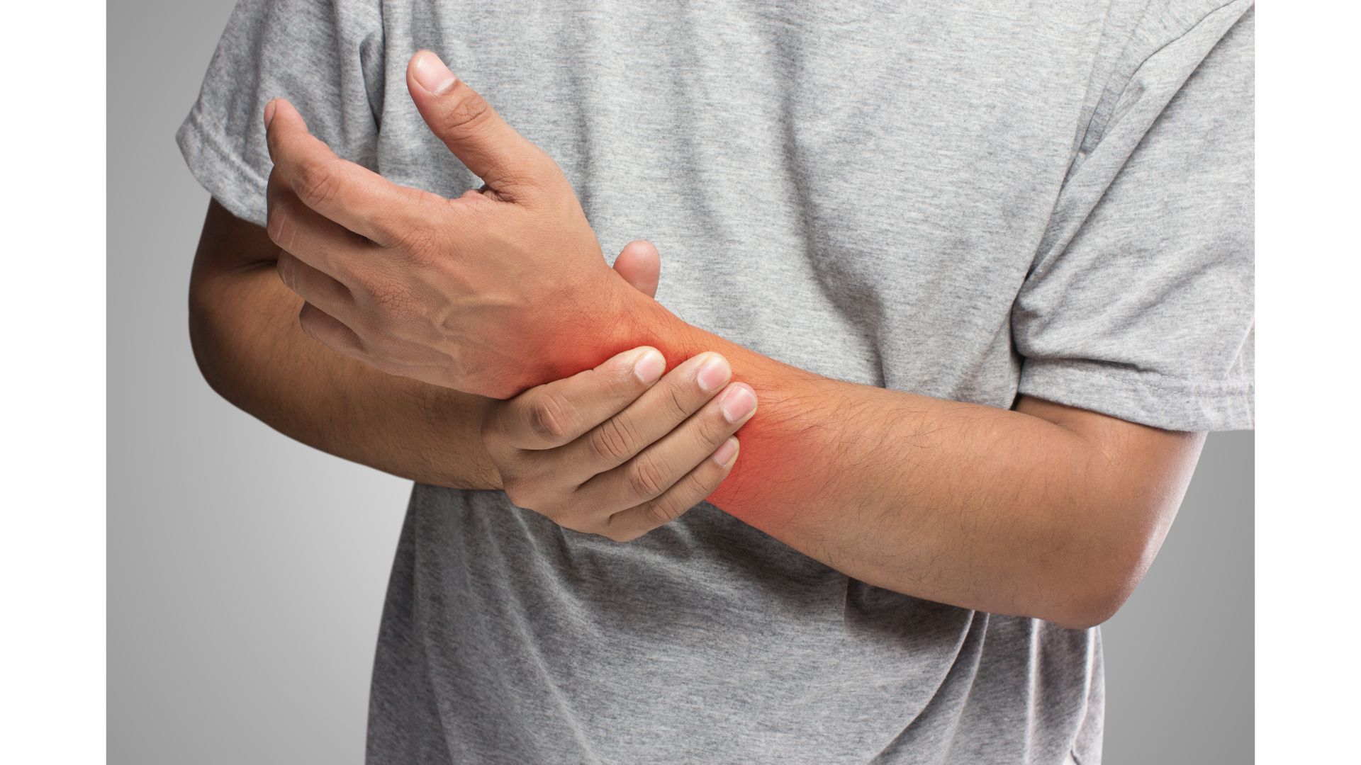 A picture of a male holding his painful wrist, showing that hypnotherapy can help you manage pain.