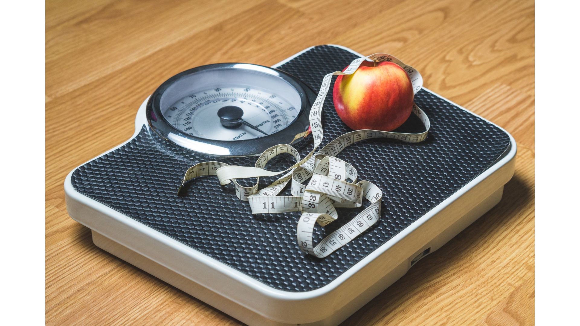 The Scales Don't Lie A picture of scales, a tape measure and an apple, showing that hypnotherapy can help with weight loss.