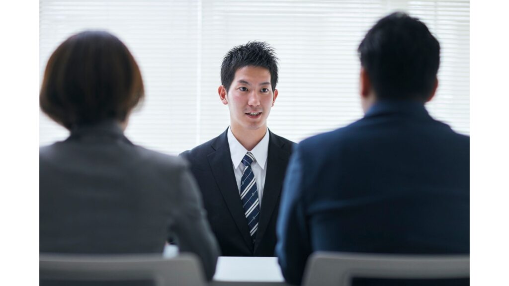 A picture of a male being interviewed by a panel, showing that hypnotherapy can help with interview nerves.